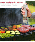 Battery Operated Salt And Pepper Grinder Set With Light Stainless Steel Mills in use over a barbecue with vegetables and steak