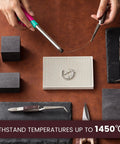 Hands using tools with Two Piece Honeycomb Ceramic Soldering Blocks Desk Top Jewelry Making Kit on brown surface