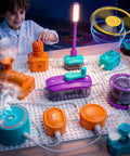Child playing with Hands On Electric Circuit Kit With Over 450 DIY Projects And 45 Parts For Kids Ages 4 To 12, components lit up