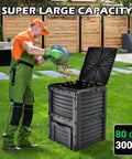Man using Outdoor Compost Bin 80 Gallon Aerated Compost Box with Top Flip Lid in a garden, large capacity for fast soil creation.