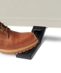 Rock Solid Drywall Foot Lifter for Standard Sheetrock Panels in use with a work boot lifting drywall easily.