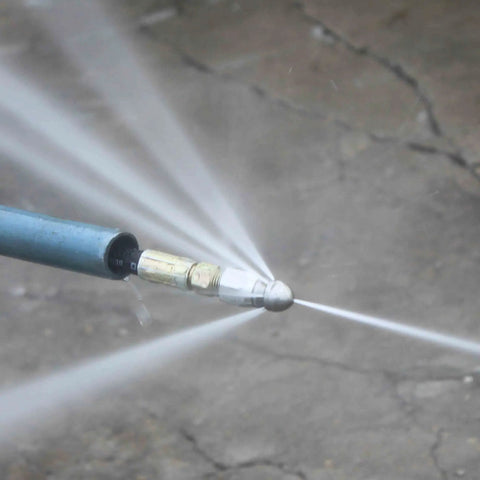 7 Pack 4000 PSI Sewer Jetter Nozzle Kit in use, showing rotating button nose spraying water for drain cleaning.