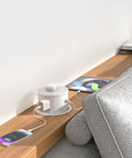 Hassle Free Slick Pop Up Outlet With Wireless Charging Pad And Fast 65W Usb Port in fresh white on a wooden desk.