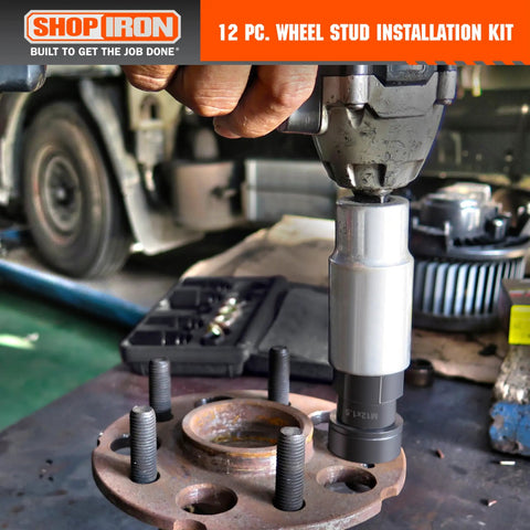 Wheel Stud Installation And Rethread Kit tool used on vehicle wheel hub in garage setting
