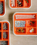 Smooth Glide Industrial Grade Carbon Steel T Slot Nuts 40 Pack Sliding Hammer Head Fasteners arranged in orange organizer boxes.