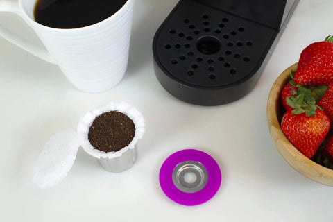 Stainless Steel Reusable K Cup For Keurig 1 Stream Coffee Pod With 25 Paper Filters, capsule lid, and coffee machine next to strawberries