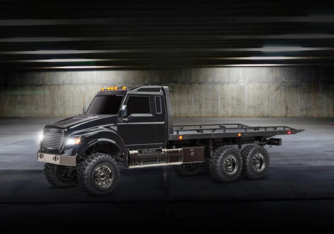 Beast 1-Tenth Scale 6WD RC Hauler With Pro Scale Winch in a dark garage setting, black design with rugged wheels.