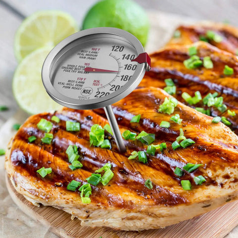 Go To All Purpose Meat Thermometer For Oven And Bbq With Large Two Point Five Inch Dial Stainless Steel Stem And Housing Oven Safe Design For Accurate Internal Temperature Readout To Make Juicy Roasts And Perfectly Cooked Steaks inserted in grilled chicken with garnishes