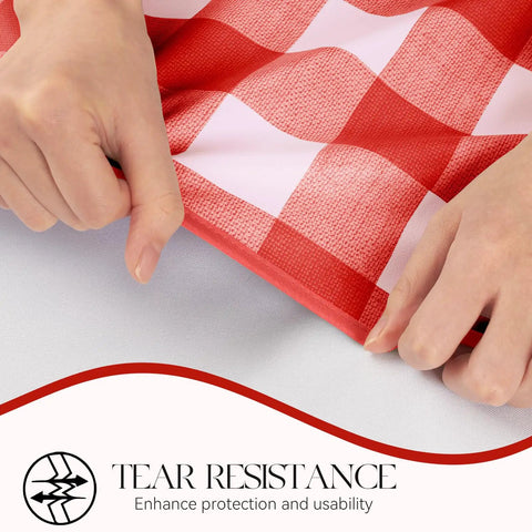 Hands displaying tear resistance of Rectangle Vinyl Tablecloth Waterproof Buffalo Gingham Red For Outdoor Picnics And Camping Heavy Duty Wipeable Table Cover 54 X 78 Inches For Parties Barbecues And Meals, with close-up of red plaid pattern.