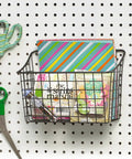 Straight Up Heavy Duty Wire Pegboard Wall Basket Rock Solid Metal Storage Bin For Garage Tools And Workshop Gear Super Handy Dual Mount Setup In Industrial Gray, filled with craft supplies, mounted on pegboard.
