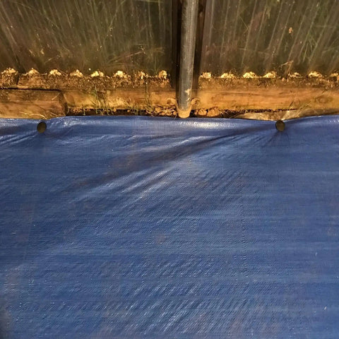 Image of blue tarp secured by 30 Pack 4.3 Inch Plastic Stakes Anchors Beefy Rustproof Thick Resin For Holding Down Landscape Fabric