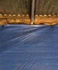 Blue tarp secured with 30 Pack 6 Inch Plastic Tarp Stakes Anchors For Garden Netting And Lawn Edging Tents And Weed Cover Beefy Heavy Duty Yard Stakes That Hold Tarps Down On Soft Ground in a garden