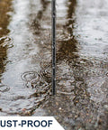 Close-up of a soil probe rod in wet ground, showing the metal structure and sharp tip. Soil Probe Rod 48 Inch Metal Locator Tool For Septic Tanks Underground Pipes Gopher Runs And Garden Soil Testing Sharp Tip Lightweight Ergonomic T Grip For Lawn And Yard Projects