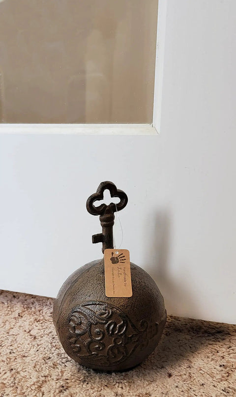 Heavy Duty Cast Iron Door Stop With Ball And Key Design, 4 lb weighted door holder in antique brown keeping door open