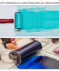 Red 0.4 Inch Rubber Brayer Roller For Wallpaper And Printmaking Pro Grade Anti Skid Hard Rubber Roller Tool shown in use with ink