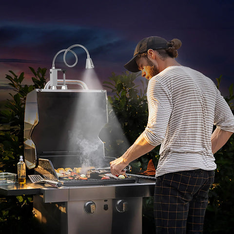 Super Bright Magnetic BBQ Grill Light With 360 Degree Gooseneck Weather Resistant Task Lighting For Outdoor Grilling Extra Long 22 Inch Flexible Spotlight Clip On Barbecue Light Gift For Men Dad Husband Silver 1 Pack illuminating a man grilling at night.