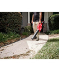 Person using M18 Fuel Dual Battery Cordless Leaf Blower For Yard Cleanup With Turbocharged Airflow And Long Runtime Pro Grade Power