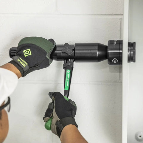 Using 8 Ton Hydraulic Knockout Punch Kit With Quick Draw Driver For Half Inch To Two Inch Holes to punch a hole in steel panel