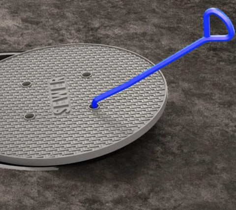 Drain Grate And Manhole Cover Lifter Heavy Duty Hook Tool lifting a sewer cover, high carbon steel, contractor grade, onsite use.