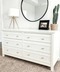 Premium Brushed Brass Cabinet Knobs 2 Inch Dresser Pulls Hardware Set 12 Pack on white dresser with modern decor.