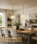 AyshwillDec 10" Modern Gold Linen Pendant Light Dining Room Bulb Included hanging over a wooden dining table with six chairs.