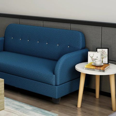 Blue sofa with adjustable plastic sofa leg set with screw on round protective feet, next to a white table with books and decor.