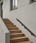 Heavy Duty Wall Mounted Stair Handrail Built From Premium Stainless Steel Providing A Rock Solid Grip And A Slick Black Finish For Dependable Daily Use And Home Safety on wooden outdoor steps.