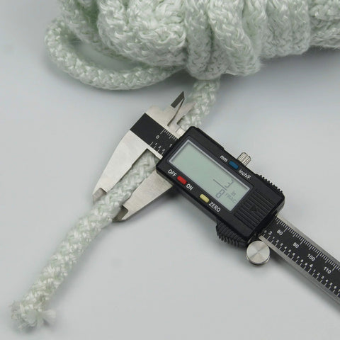 Lynn Manufacturing high-temperature gasket rope, white, 3/8 in dia x 25 ft (1000F), shown with digital caliper
