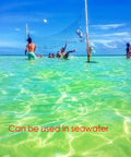 People playing volleyball with All Weather Outdoor Volleyball Net Beefy Heavy Duty For Backyard Beach Or Poolside Play Regulation 32x3 Feet