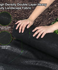 Hands installing Heavy Duty 5oz Weed Barrier Landscape Fabric Pro Grade Dual Layer Ground Cover in garden