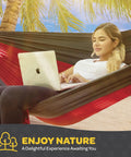 Woman using laptop in Heavy Duty Nylon Camping Hammock Chair With 500 Lb Capacity, Double Or Single Size, Comes With Tree Straps And Packed Carry Bag, Ultra Portable For Travel, Backpacking, Beach Or Backyard Hangouts on beach