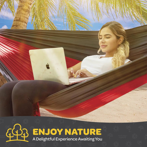 Woman using laptop in Heavy Duty Nylon Camping Hammock Chair With 500 Lb Capacity, Double Or Single Size, Comes With Tree Straps And Packed Carry Bag, Ultra Portable For Travel, Backpacking, Beach Or Backyard Hangouts on beach