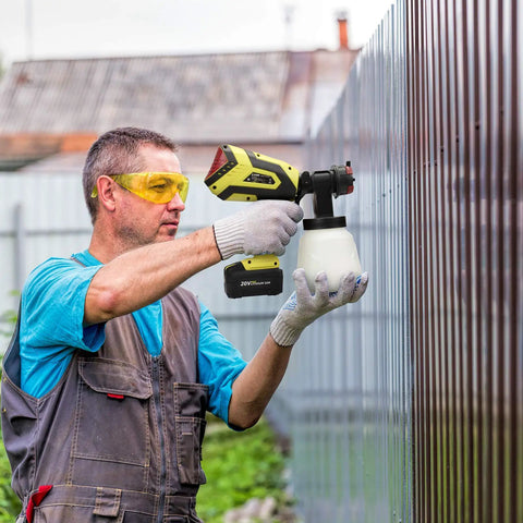 Man using Cordless Paint Sprayer Gun With 4.0Ah Battery And Fast Charger 550W HVLP Sprayer For Home Interior And Exterior