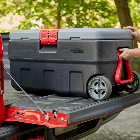 ActionPacker 35 Gallon Lockable Storage Bin with Wheels placed on truck bed for outdoor use