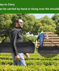 Man carrying 20 Inch Grill Tool Organizer Bag Heavy Duty Waterproof 600D Oxford Folding Storage over shoulder in park.