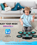 Child playing 9 Pad Electronic Drum Set With Dual Speakers Portable MIDI Practice Kit For Beginners in living room with headphones
