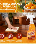 A person using Top Shelf 2 In 1 Wood Cleaner And Furniture Polish Featuring Pure Orange Oil Spray on a wooden table.