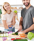 Andibro 4-piece onion slicer set with stainless steel blades and blue and orange plastic handles on a kitchen counter.