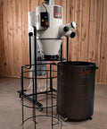Professional 3 Hp 230 Volt Cyclone Dust Collector With 2 Micron Pleated Filter and Wireless Remote Timer Shut Off beside a black drum.