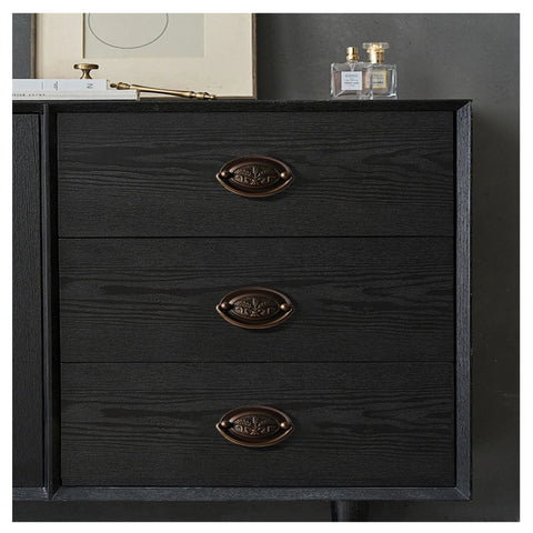 Dresser with Vintage Oval Drop Swing Drawer Pulls in Antique Brass, Zinc Alloy Hardware, installed on black wood surface, 3 drawers visible.