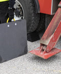 Person holding HDPE Outrigger Pad 24x24x1 Inch Beefy Heavy Duty Jack Pad next to tire and metal jack arm with rope handle visible