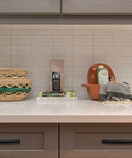 Modern kitchen with matte black Six Inch Curved Cabinet Pulls on drawers and decorative items on countertop.