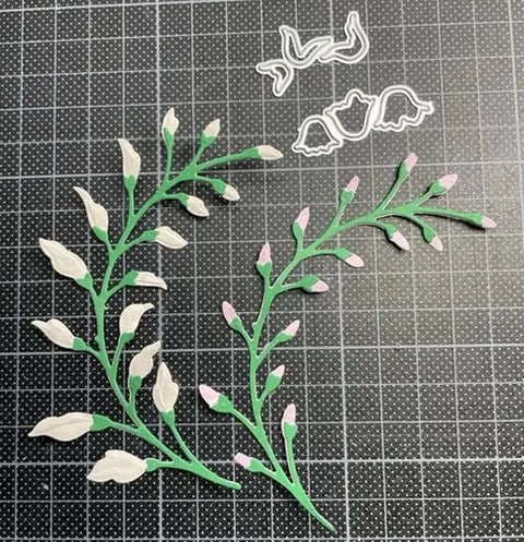 3 Piece Flower Leaf Branches Metal Die Cuts Set For DIY Embossing And Card Making with floral leaves frame stencils on a grid mat.
