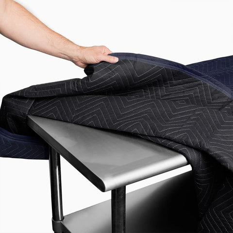 Pro Economy Moving Blanket 80 By 72 Inches Premium Quilted Shipping Furniture Pad navy blue and black on stainless table