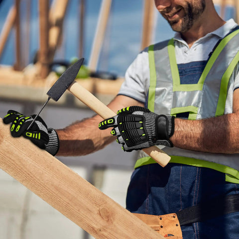 Worker wearing heavy duty work gloves for men with ANSI cut level A5 protection, using a hammer on a construction site.