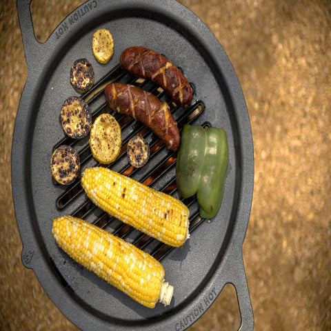 Grilled vegetables and sausage on cast iron pan, illustrating need for Cast Iron Scrubber With Stainless Chainmail And Silicone Center.