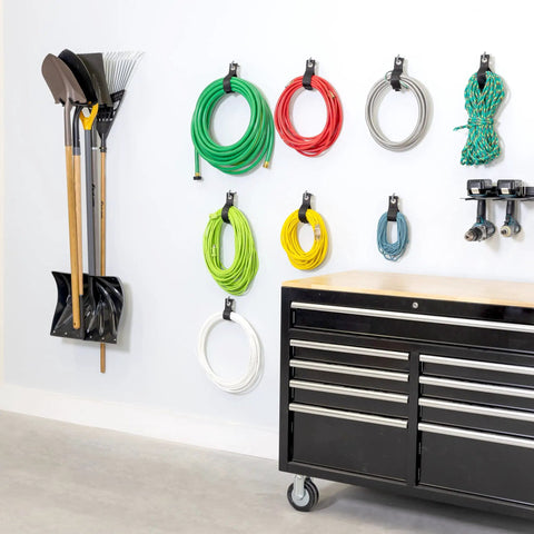 Heavy Duty Garage Wall Mount Tool Hook Rack For Shovels Rakes Brooms Hoses And Cords Industrial Steel Powder Coated Design Holds Up To 50 Pounds Ultra Strong Yard And Workshop Organizer For Easy Access with multiple hoses and tools in a garage setting.