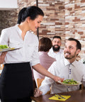 Waitstaff in black pro waist apron with 3 pockets serving salad, restaurant setting, wearing water-resistant durable polyester half apron.
