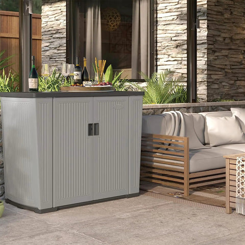 130 Gallon Outdoor Storage Cabinet With Lockable Door Backyard Oasis Basic Unit Peppercorn Finish on a patio with plants and sofa.