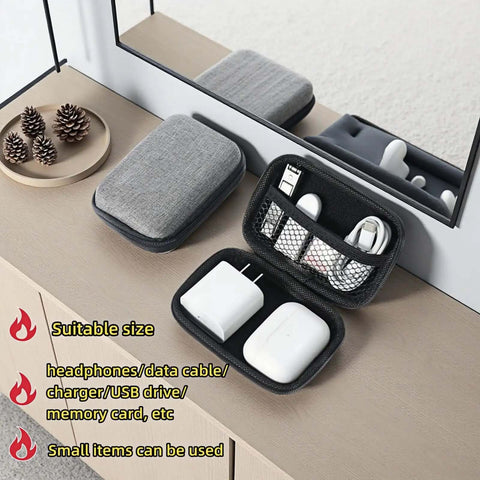 Road Ready Hard Shell Tech Organizer Case With Water Repellent Coating And Shock Absorbing Build designed for packing cables and chargers on a table.